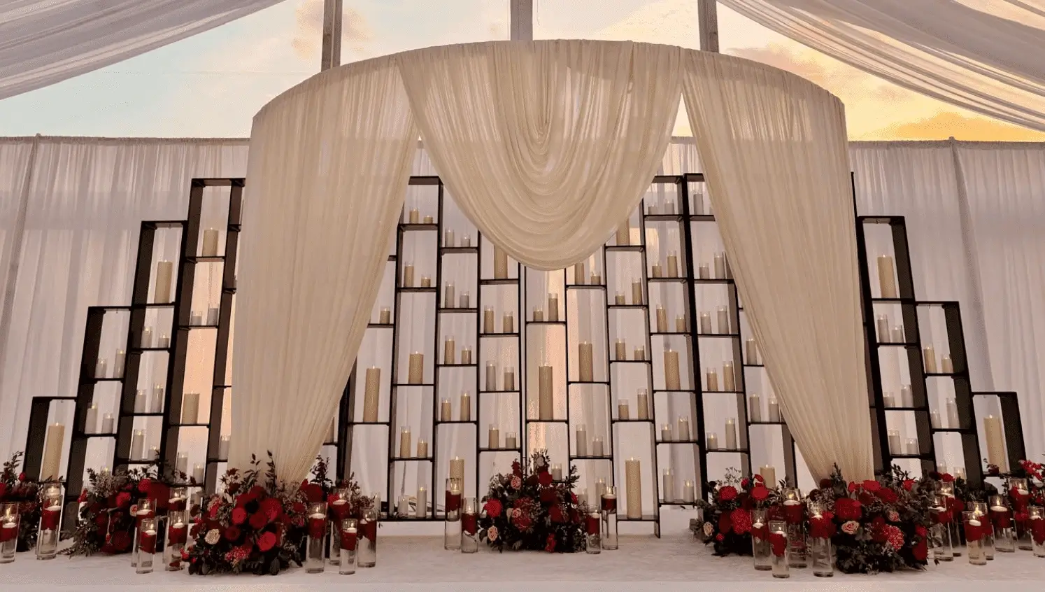 Reception scene framed by tapered candles and blush blooms