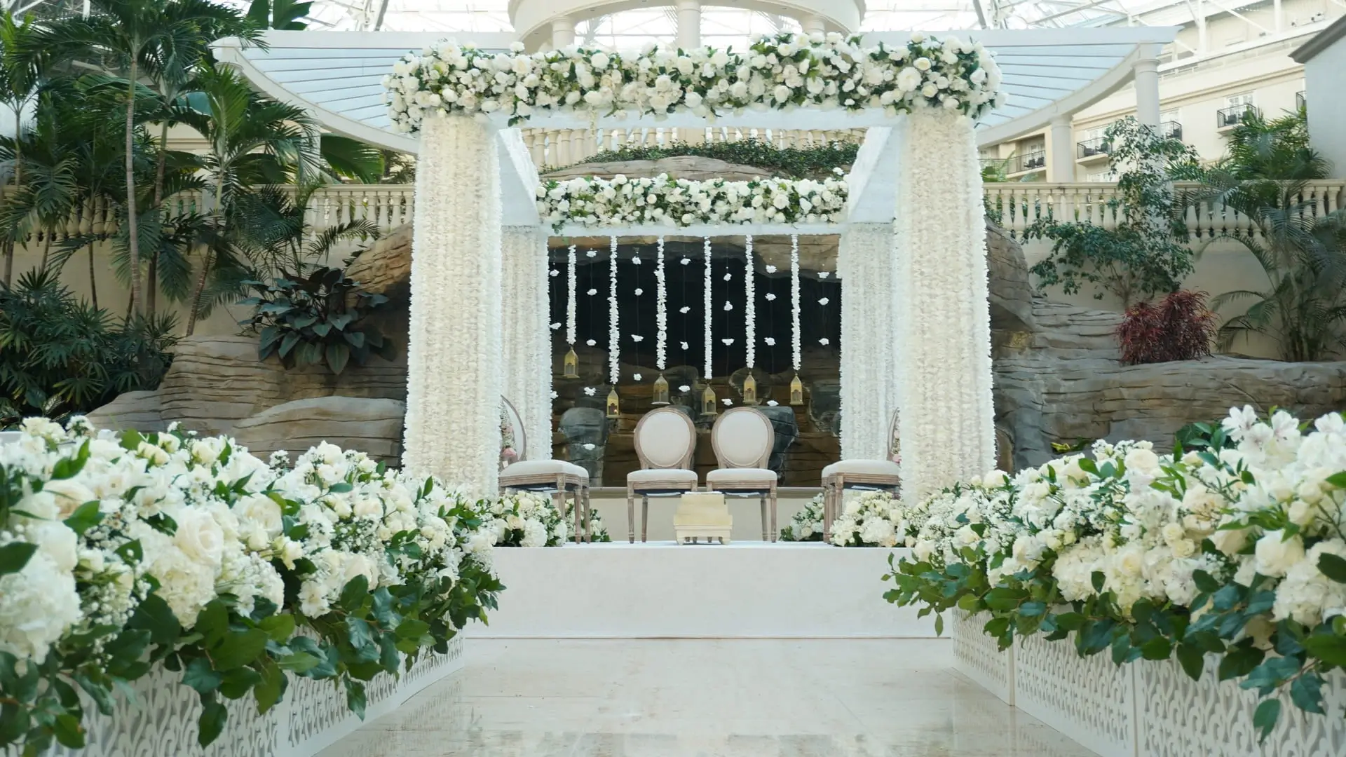 Welcome lounge styled with brass, candles, and florals