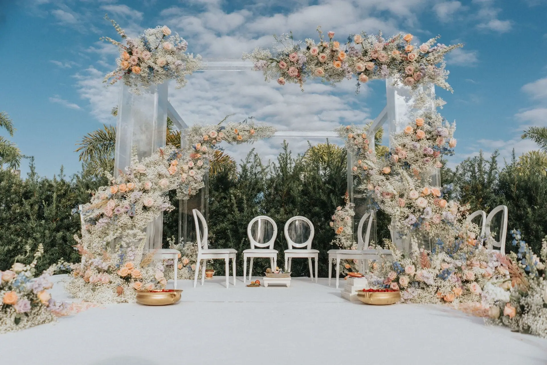 Ceremony aisle framed by floral arrangements