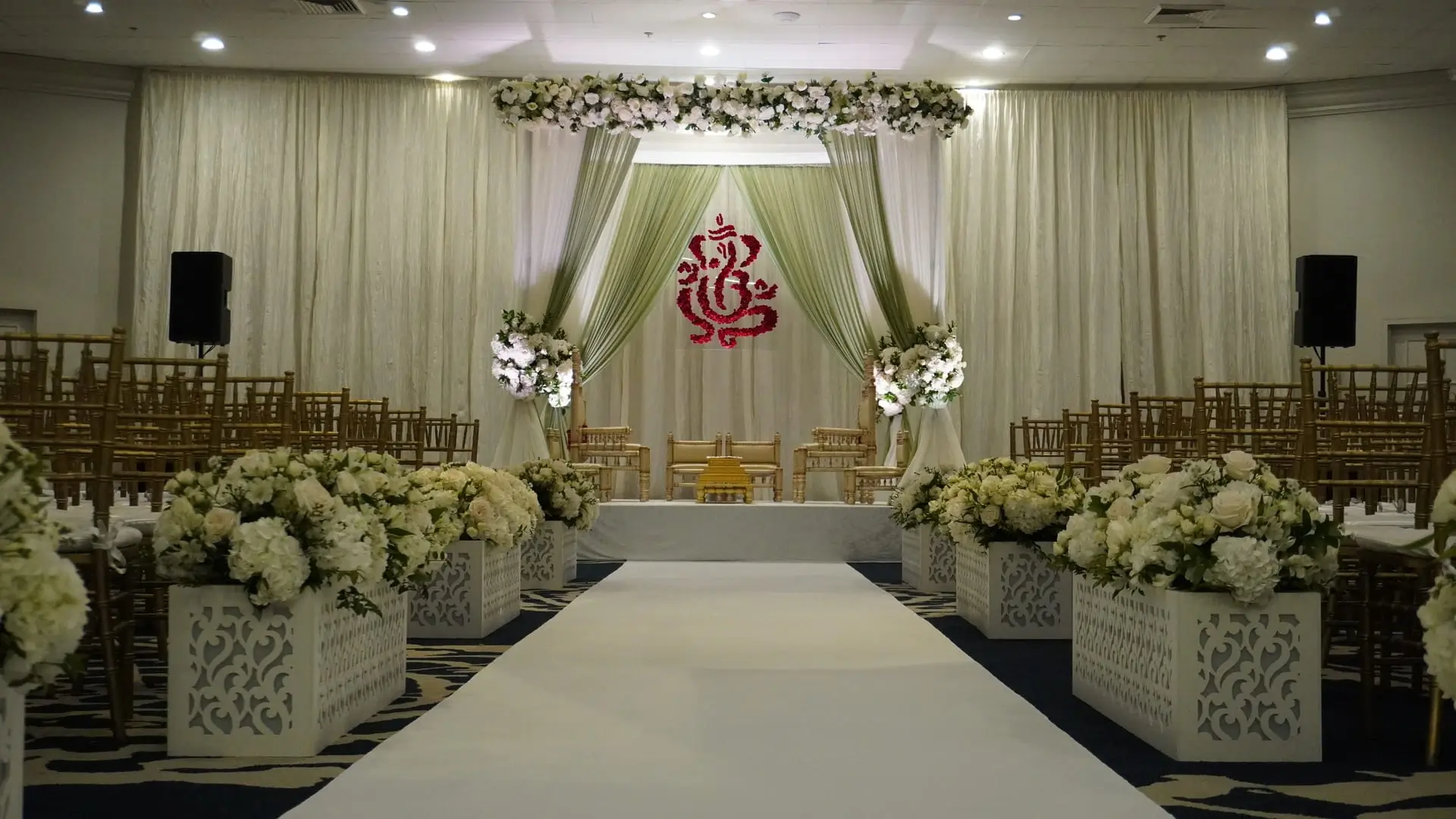 Wide reception decor with chandeliers and floral runners