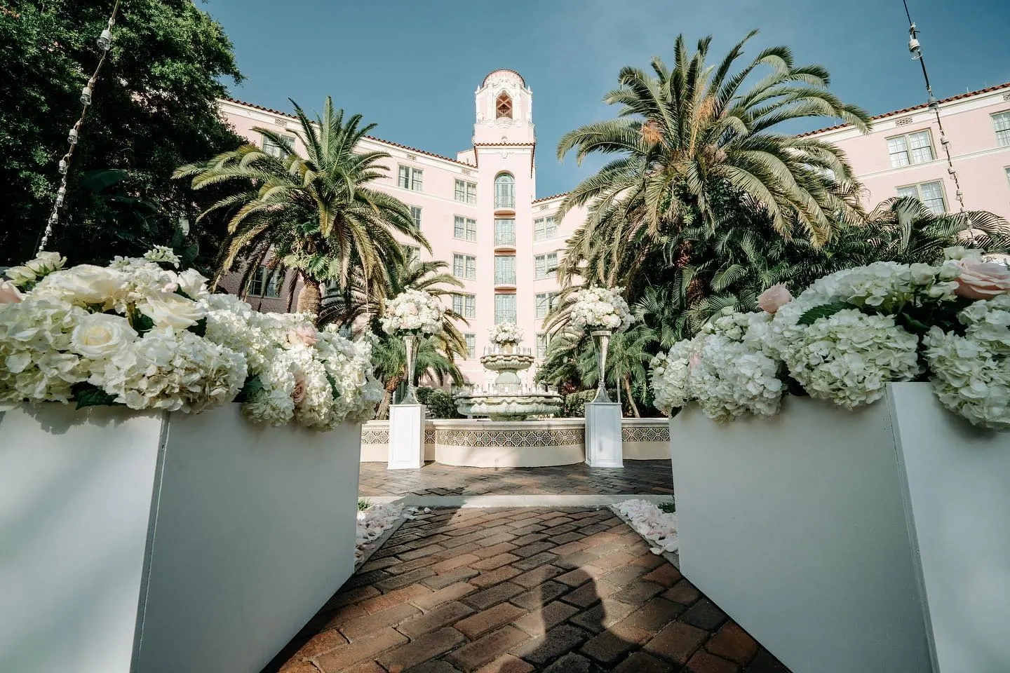 Pink Vinoy hotel courtyard with white hydrangea ceremony entrance